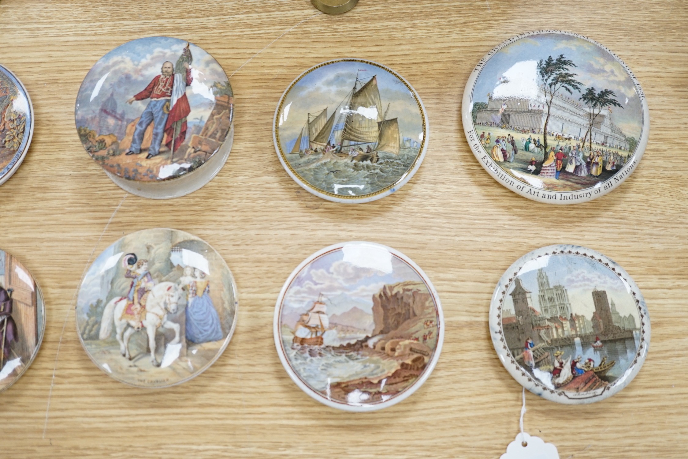 A collection of sixteen mainly 19th century Prattware pomade pot lids